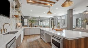 a large kitchen with white cabinets and a large island at Large Lively Apt in San Marcos