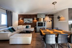 a living room with a table and a dining room at Villa Kalac, a charming holiday pool oasis near the sea in Raša