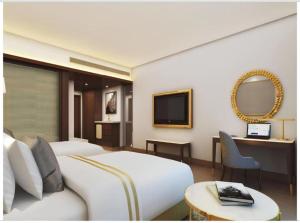 a hotel room with two beds and a television at Tejsvhi Hotel Aerocity in Jāmb