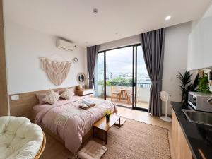 een slaapkamer met een bed en een groot raam bij BaBô Homestay Da Nang in Da Nang