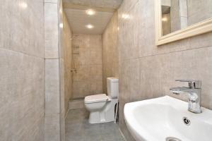 a bathroom with a white toilet and a sink at tumanyan 38 guest hause in Yerevan