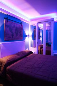 a bedroom with a large bed with a blue lighting at Hotel Miravalle in Naples