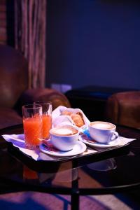 a tray with two cups and drinks on a table at Hotel Miravalle in Naples