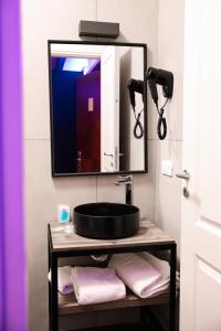 a bathroom with a sink and a mirror at Hotel Miravalle in Naples