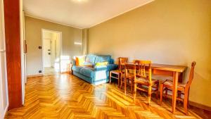a living room with a blue couch and a table at Appartamento Cristallo - Affitti Brevi Italia in Bardonecchia