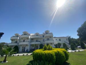 a large white building with the sun in the sky at Hotel Resort Comfort in Ulcinj