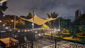 a tent on a balcony at night with lights at Casa Mariscal in Guatemala