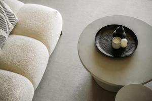 a table with two candles on it next to a couch at Ermioni Countryside Residence by Konnect, Agios Markos in Ágios Márkos