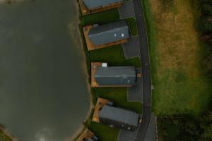 an overhead view of a house next to a body of water at Landal Twin Lakes in Carnforth +8 photos