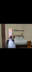 a bedroom with a bed with the words discharge room on the wall at Hotel PB Thana in Shillong