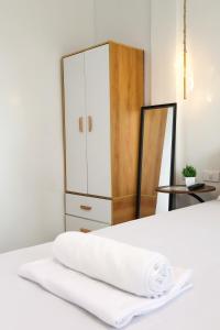 a bedroom with a white bed and a cabinet at Felicitas Extension Room in General Luna