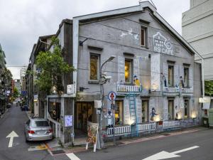 a building with a car parked in front of it at Holiday Inn Express Taipei Train Station by IHG in Taipei