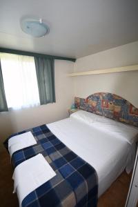 Ένα ή περισσότερα κρεβάτια σε δωμάτιο στο Centro Vacanze San Marino