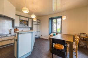 a kitchen with a table and a dining room at Appartement d'exception - proche de la mer in Saint-Brieuc
