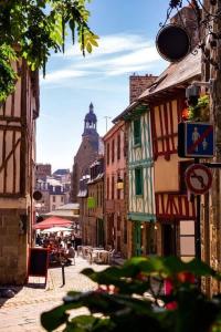 a city street with a clock tower in the distance at Appartement d'exception - proche de la mer in Saint-Brieuc +26 photos
