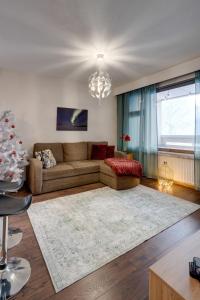 a living room with a couch and a christmas tree at Matti's Charming Studio in Rovaniemi