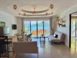 a living room with a kitchen and a dining room at Secret Place in Panwa Beach