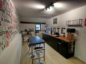 a kitchen with a desk and a table in a room at Barotel - Bed & Dinner in Floreffe