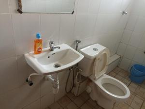 a bathroom with a toilet and a sink at Jay homes in Kakamega
