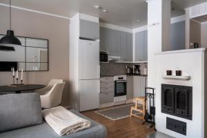 a living room with a couch and a kitchen at Cozy and peaceful holiday apartment in Levi in Levi