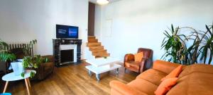 a living room with a couch and a fireplace at Maison 6 personnes Angouleme in Angoulême