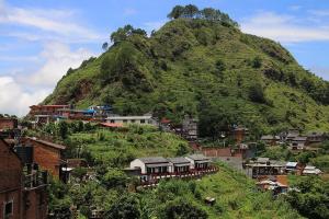 a hillside with houses and a mountain at Gaun Ghar Pvt Ltd in Bandipur