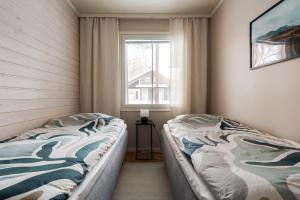 a bedroom with two beds and a window at Cozy and peaceful holiday apartment in Levi in Levi