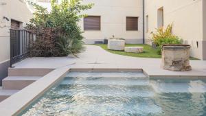a pool in the courtyard of a building at San Torcuato VIII by Toledo AP in Toledo