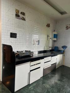 a kitchen with a stove and a counter top at 3BHKVilla Panshet in Lavasa