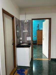 a kitchen with a sink and a door to a room at 3BHKVilla Panshet in Lavasa +7 photos