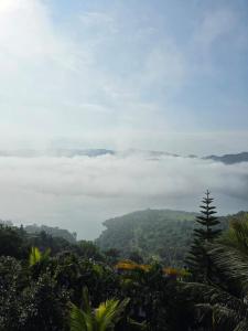a view of a mountain with clouds in the distance at 3BHKVilla Panshet in Lavasa