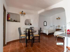 a room with a table and chairs and a bed at Living Artenara - CAVE HOUSE & TERRACE Adults Only in Artenara +70 photos