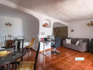 a living room with a couch and a table at Living Artenara - CAVE HOUSE & TERRACE Adults Only in Artenara