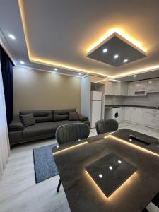 a living room with a couch and a table at Loft House Studio in Arnavutköy