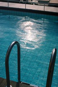 a swimming pool with blue water at Il Capri Hotel in Capri