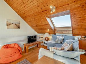 a living room with a blue couch and a window at 2 Bed in Haverigg 94052 in Haverigg