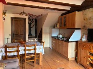 a kitchen with a table and some chairs and a kitchen with a table at Casa Rural Senderismo in Lumbreras