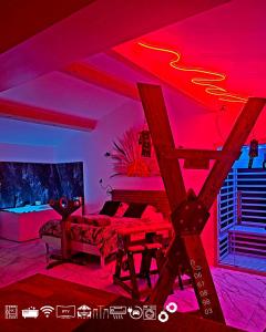 a living room with pink lighting and a couch at Maisons Plaisir & Pulsion Spa Sauna Privé in Allauch