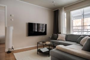 a living room with a couch and a table at Cozy and peaceful holiday apartment in Levi in Levi