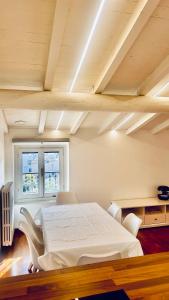 ein Schlafzimmer mit einem weißen Bett und zwei Stühlen in der Unterkunft Casa MiA in Salò