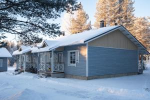 a house with snow on top of it at Cozy and peaceful holiday apartment in Levi in Levi