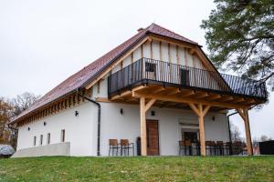 a house with a balcony on top of it at Vineyard Escape Herbersteinova klet in Juršinci