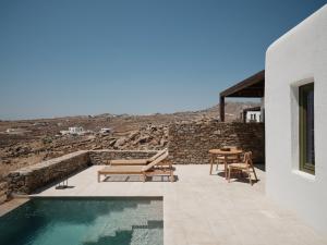 a house with a pool and a table and chairs at Armacaas Mykonos Hotel in Super Paradise Beach +42 photos
