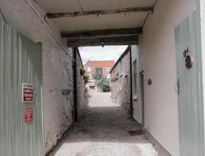 an empty alley with an entrance to a building at Platform 17 in Pickering +45 photos