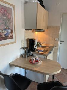 a kitchen with a table with a coffee maker on it at Ferienwohnungen Albers in Winterberg +15 photos