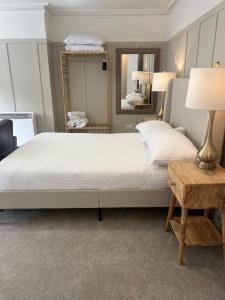 a bedroom with a large bed and a mirror at The OXTED high street studio in Oxted
