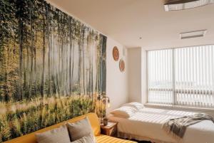 1 dormitorio con un gran mural de árboles en la pared en Cozy - Good Vibes Studio, en Incheon