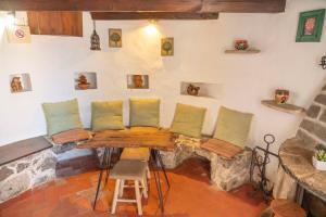 a table and chairs in a room with a fireplace at Moinho da Senta in Rio Maior