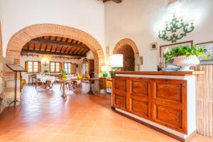 a large room with a kitchen and a dining room at Hotel Monteriggioni in Monteriggioni