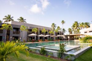 an exterior view of a resort with a swimming pool at Paraíso no patacho - Rota de Milagres in Pôrto de Pedras